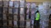 An IEBC official inspects ballot boxes at Kasarani gymnasium, Nairobi, March 5, 2013.