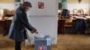 A woman casts her ballot during the country's first-ever direct presidential election to replace the outgoing president Vaclav Klaus, in Prague January 11, 2013.