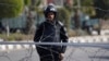 FILE - A police officer stands guard outside a police academy.