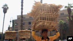 Men sell bread in front of Al-Hussein mosque, near a popular tourist area in old Cairo, Oct. 29, 2013.