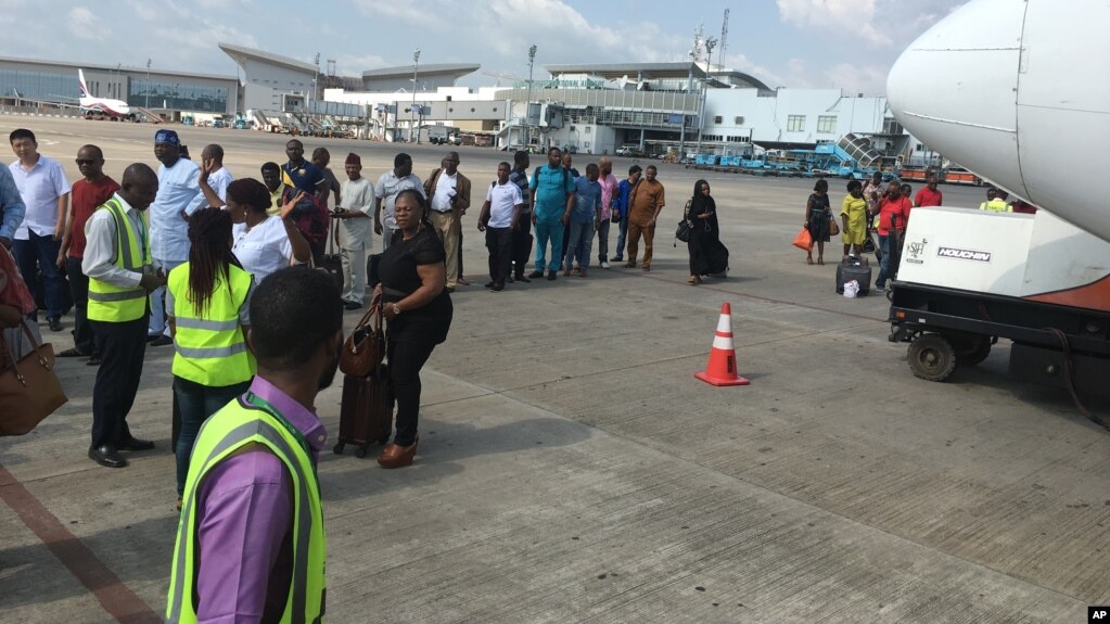 FILE - Passengers are searched before boarding a flight at the Nnamdi Azikiwe International Airport in Abuja, Nigeria, Oct. 15, 2016. Nigeria will close the airport for six weeks to repair the runway.