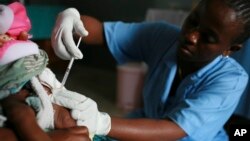 FILE - A child is vaccinated during a Malaria vaccine trial in Bagamoyo, Tanzania, August 2007. 