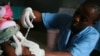 FILE - A child is vaccinated during a malaria vaccine trial in Bagamoyo, Tanzania in Aug. 2007. 