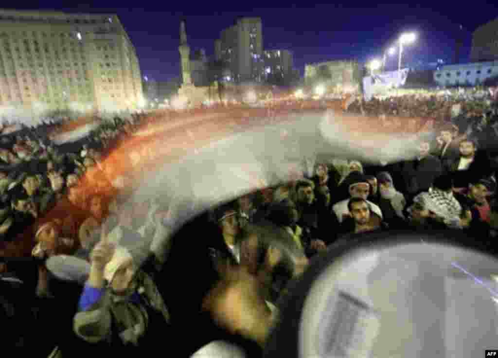Anti-government protesters celebrate as they wave an Egyptian flag in Tahrir Square in downtown Cairo, Egypt Thursday, Feb. 10, 2011. Egypt's military announced on national television it had stepped in to secure the country and promised protesters calling