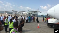 Des passagers passent à un contrôle avant de prendre un avion à l'aéroport d'Abuja, Nigeria, 15 octobre 2016.