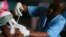 FILE - A child is vaccinated during a Malaria vaccine trial in Bagamoyo, Tanzania, August 2007. 