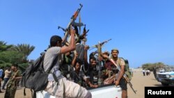 FILE - Houthi militants ride on the back of a truck in the Red Sea city of Hodeidah, Yemen, Dec. 29, 2018. 