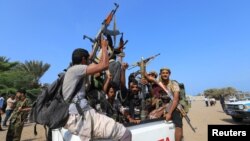 FILE - Houthi militants ride on the back of a truck in the Red Sea city of Hodeida, Yemen, Dec. 29, 2018. 