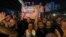 Участники акции протеста против гей-прайда в Тбилиси держат в руках плакат с изображением Келли Дегнан, посла США в Грузии