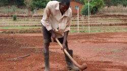 Police officer Kanduwa Sande works on the sports complex he is voluntarily building on public land. (Lameck Masina./VOA)