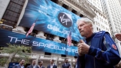 Sir Richard Branson, right, founder of Virgin Galactic, and company executives gather for photos outside the New York Stock Exchange before his company's IPO, Monday, Oct. 28, 2019.