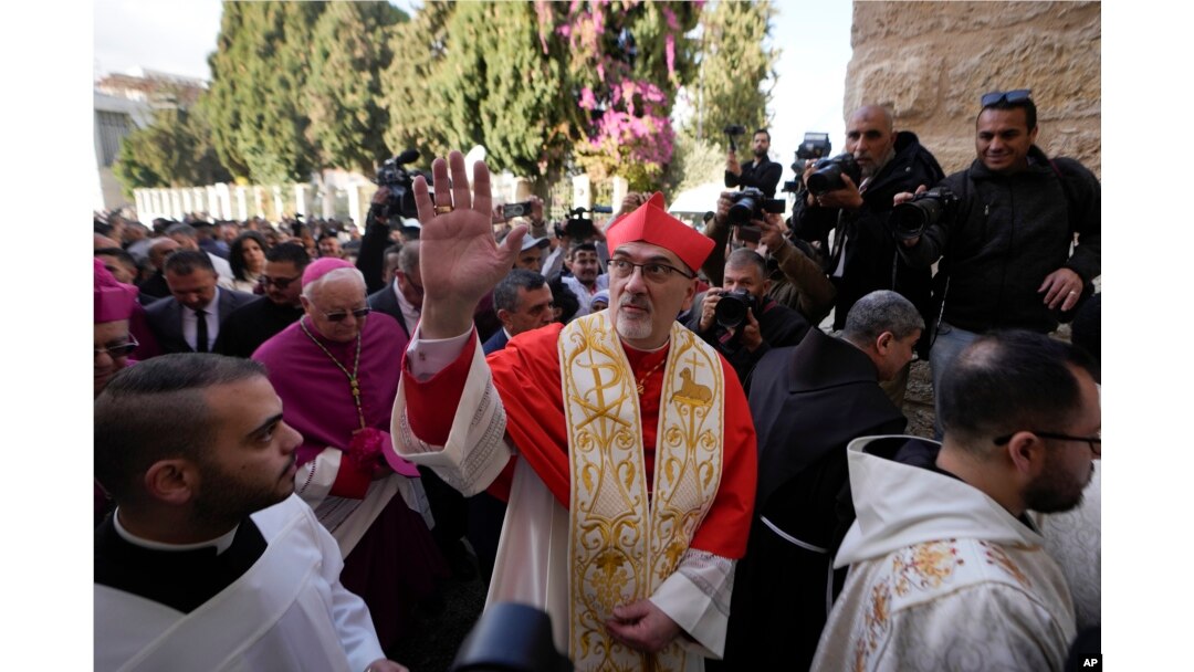 Latin Patriarch Pierbattista Pizzaballa, the top Catholic clergyman in the Holy Land, waves as he arrives at the Church of the Nativity on Christmas Eve in the West Bank city of Bethlehem, Dec. 24, 2024.