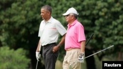 President Barack Obama and Malaysia's Prime Minister Najib Razak walk off 18th hole while playing a round of golf at the Clipper Golf course on Marine Corps Base Hawaii during Obama's Christmas holiday vacation in Kaneohe, Hawaii, December 24, 2014.