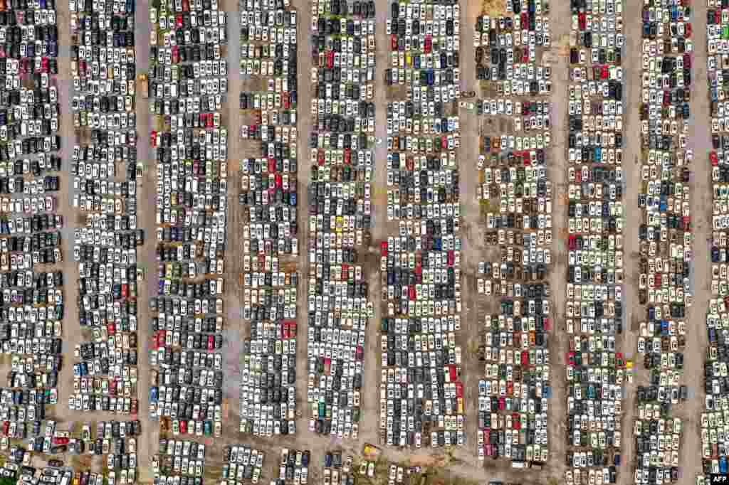 This aerial photo shows vehicles damaged by floods in July at a parking lot, some of which will be discarded, in Zhengzhou in China&#39;s central Henan province, Aug. 10, 2021.