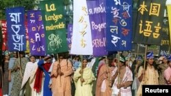 ڈھاکہ میں خواتین مادری زبانوں کے عالمی دن کے موقع پر بنگلہ دیش میں بولی جانے والی مختلف زبانوں کے بینر اٹھائے ہوئے ہیں۔ فائل فوٹو