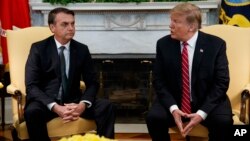 President Donald Trump speaks during a meeting with Brazilian President Jair Bolsonaro in the Oval Office of the White House, March 19, 2019, in Washington. 