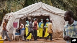 FILE - Health workers prescreen people for the deadly Ebola virus before they enter the Kenema Government Hospital in Kenema, Sierra Leone.