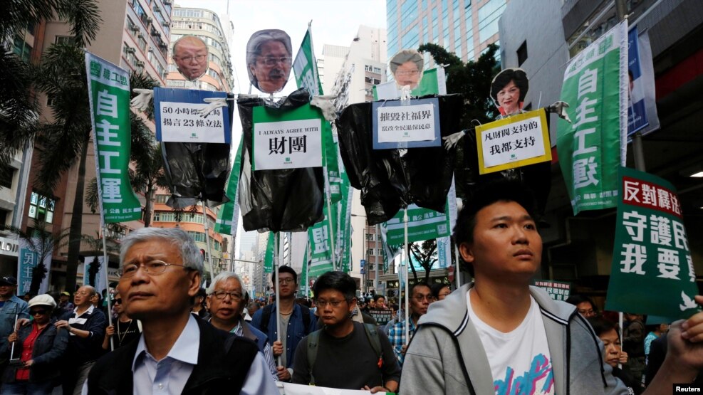 香港示威者举着标语牌：“反对释法，撤回复核，守护民选制度，我要真普选”（2017年1月1日）