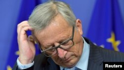 FILE - European Commission President Jean-Claude Juncker, pictured at a Brussels news conference in July, says the EU will lose "all kinds of credibility" if aid pledges to help with the migrant crisis aren't met.