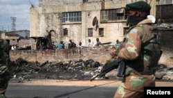 Members of the military patrol through the streets of Alexandra township as the country deploys the army to quell unrest linked to the jailing of former President Jacob Zuma, in Johannesburg, South Africa, July 15, 2021. 