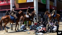 Police on horses surround protesters during protests against abductions in Nairobi, Dec. 30, 2024.