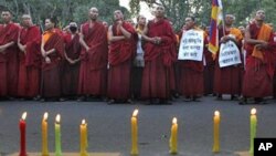 Tibetan exile monks stand during a candlelit vigil in New Delhi, India, to express solidarity with the plight of the Tibetan people.