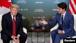 FILE - U.S. President Donald Trump, left, meets with Canada’s Prime Minister Justin Trudeau in a bilateral meeting at the G-7 Summit in Charlevoix, Quebec, Canada, June 8, 2018. 