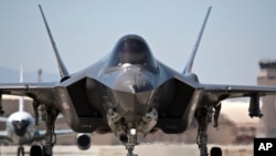 FILE - In this photo released by Lockheed Martin, an F-35 fighter taxis at Edwards Air Force base, May 12, 2012.