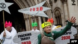 British fashion designer Vivienne Westwood, dressed as an angel, poses with other anti-fracking activists.as they demonstrate at Britain's High Court, in central London. Taken December 18, 2018