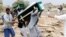 FILE - Mourners carry coffins during a funeral of people, mainly children, killed in a Saudi-led coalition airstrike on a bus in northern Yemen, in Saada, Yemen, Aug. 13, 2018. 