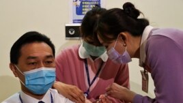 A medical worker receives a dose of the AstraZeneca vaccine against the coronavirus disease (COVID-19) during a vaccination for medical workers in Taipei, Taiwan, March 22, 2021. REUTERS/Ann Wang