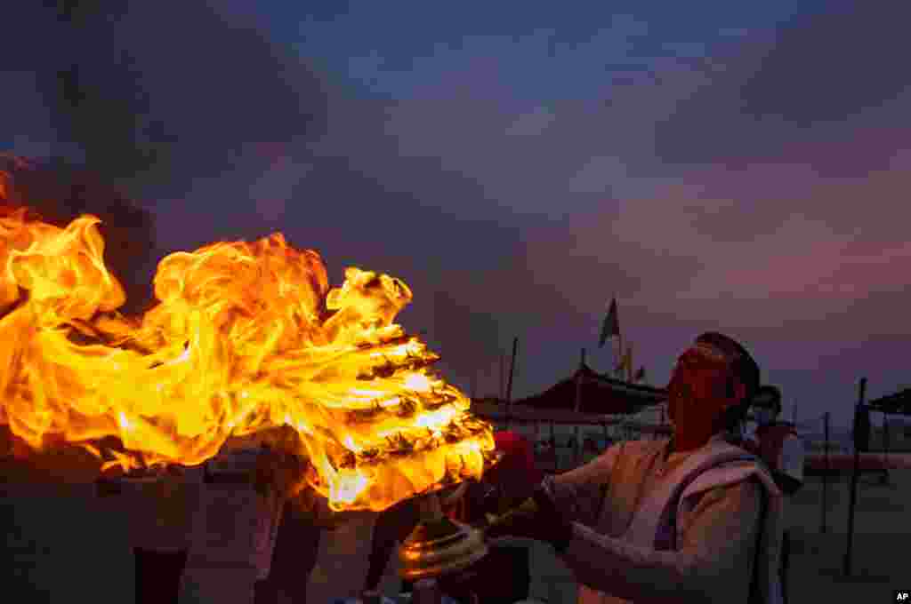 A Hindu priest performs an evening ritual &quot;Aarati&quot; at Sangam, the confluence of the Ganges and Yamuna Rivers, on Ramnavami in Prayagraj, India.