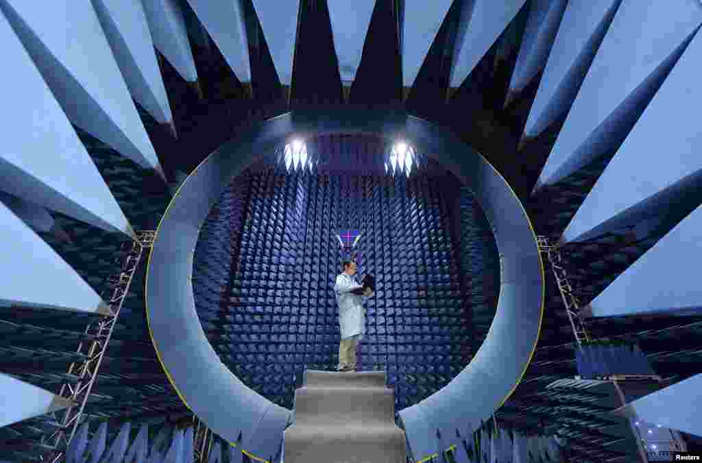 An employee conducts tests of an antenna at a factory of FiberHome Technologies Group, in Wuhan, Hubei province, China.