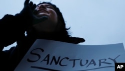 FILE - Demonstrators chant against President Donald Trump's immigration policies in Cincinnati, Ohio, Jan. 30, 2017.