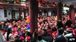 This photo taken on Dec. 24, 2017, shows Chinese Christians attending a Christmas Eve mass at a church in Fuyang in China's eastern Anhui province. 