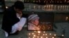 Afghan men light candles for Japanese Dr. Tetsu Nakamura, who was killed in Jalalabad in a terrorist attack, in Kabul, Afghanistan, Dec. 5, 2019.