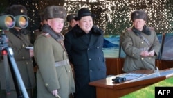 Undated photo released by North Korea's official Korean Central News Agency (KCNA) on Feb. 21, 2016 shows North Korean leader Kim Jong-Un (C) inspecting maneuvers for attack and defense between large combined units of the Korean People's Army (KPA).