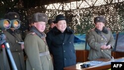 FILE - Undated photo released by North Korea's official Korean Central News Agency (KCNA) on Feb. 21, 2016 shows North Korean leader Kim Jong-Un (C) inspecting maneuvers for attack and defense between large combined units of the Korean People's Army (KPA).