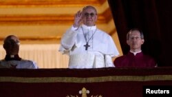 Newly elected Pope Francis, Cardinal Jorge Mario Bergoglio of Argentina appears on the balcony of St. Peter's Basilica after being elected by the conclave of cardinals, at the Vatican, March 13, 2013. White smoke rose from the Sistine Chapel chimney and t