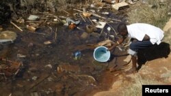 Residences of Mabvuku fetch water from unprotected sources in Harare, Zimbabwe, July 28, 2012.