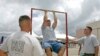 FILE - Matt Elam, center, competes in a US Marine pull-up contest while Marine recruiters watch.