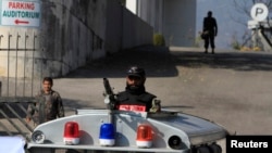 FILE - A paramilitary soldier stands guard outside a court building in Islamabad, Pakistan, Jan. 2, 2014.