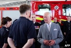 Britain's King Charles III meets with representatives from Merseyside's emergency services and local community groups at the Community Fire Station in Southport, U.K., on Aug. 20, 2024.