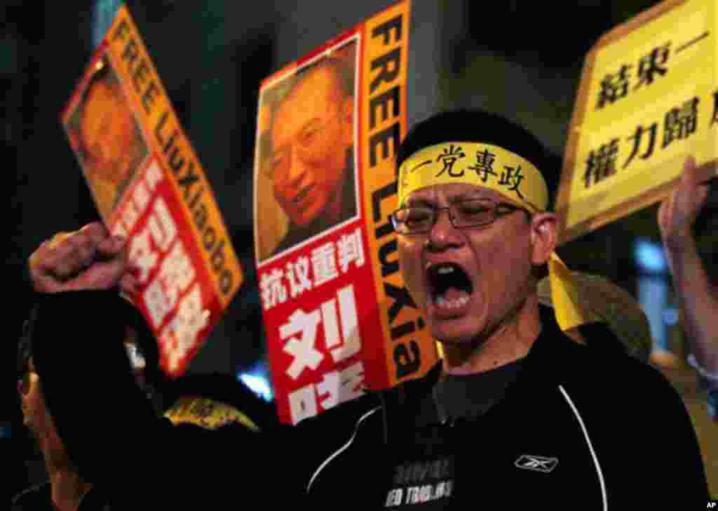 Pro-democracy protesters hold the picture of Chinese dissident Liu Xiaobo during a demonstration outside the China's Liaison Office in Hong Kong Friday, Oct. 8, 2010. Imprisoned Chinese dissident Liu Xiaobo won the 2010 Nobel Peace Prize on Friday for usi