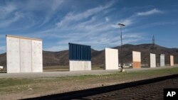 FILE - Border wall prototypes stand in San Diego near the Mexico-U.S. border, seen from Tijuana, Dec. 22, 2018.