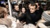 French President Emmanuel Macron shakes hands with visitors of the Christmas market in Strasbourg, France, Dec. 14, 2018. 
