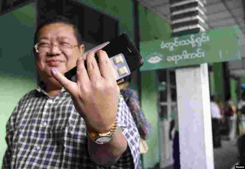 A man shows his finger with indelible ink after casting his vote for the general election at a polling station in Yangon November 8, 2015. Voting began on Sunday in Myanmar's first free nationwide election in 25 years, the Southeast Asian nation's biggest