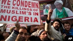 FILE - Kashmiri Shi’ite Muslims shout slogans against the Nigerian government after the army killed 348 members of a Shi'ite minority sect and detained the group’s leader during an altercation there in December, in Srinagar, Indian-controlled Kashmir, Dec. 18, 2015.