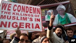 FILE - Kashmiri Shiite Muslims shout slogans against the Nigerian government in Srinagar, Indian-controlled Kashmir, Dec. 18, 2015