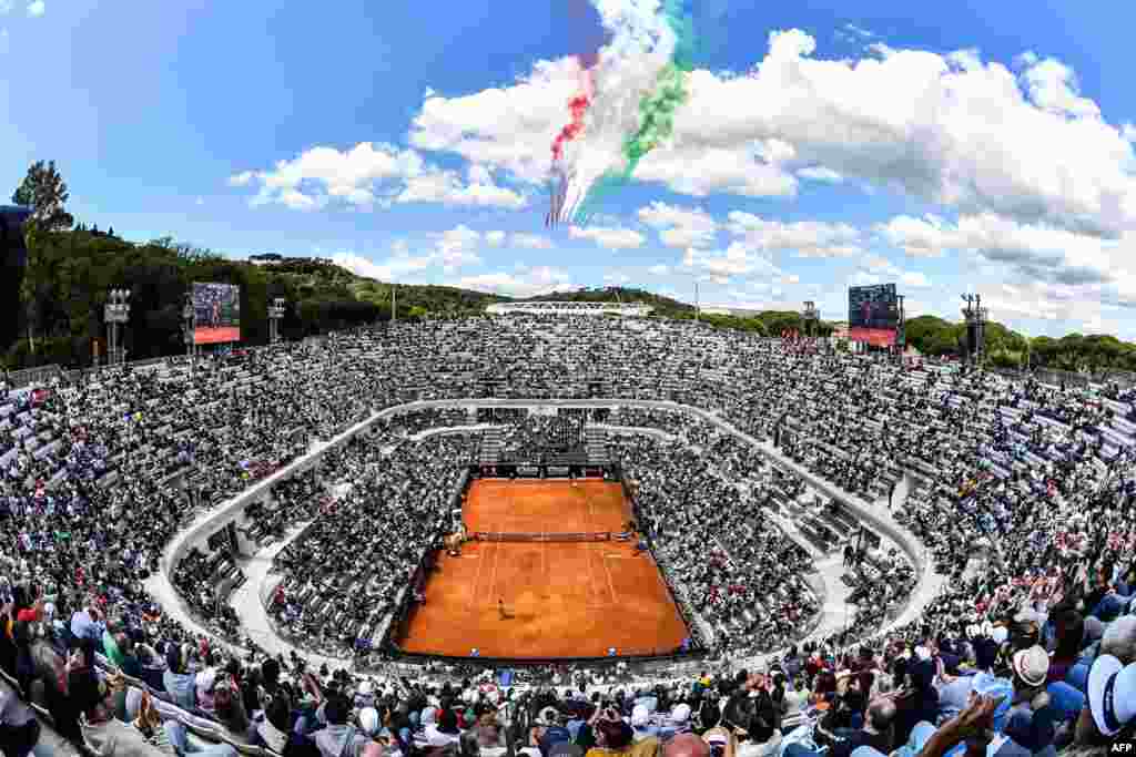 The Frecce Tricolori air squadron flies over the Foro Italico as Serbia&#39;s Novak Djokovic plays against Canada&#39;s Denis Shapovalov during their ATP Masters tournament tennis match in Rome, Italy.